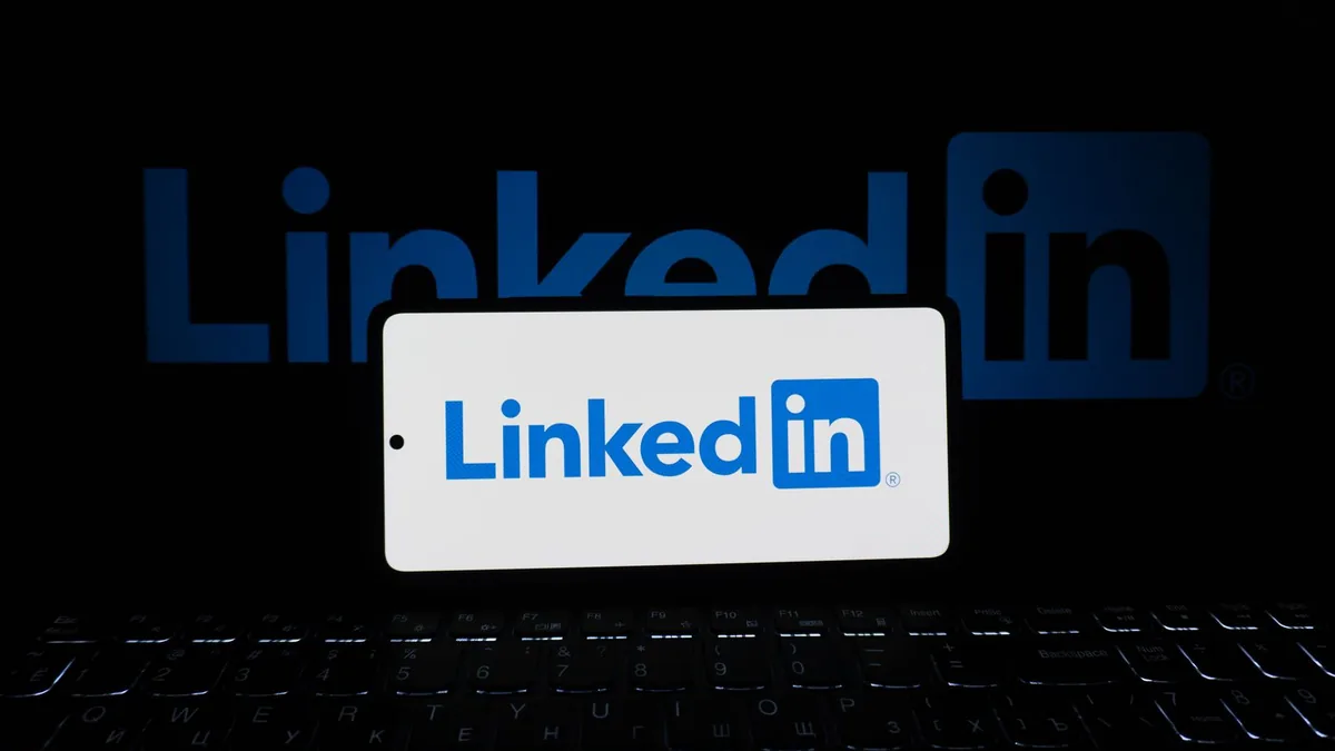Smartphone showing the LinkedIn logo, the channel in LinkedIn outreach vs cold email