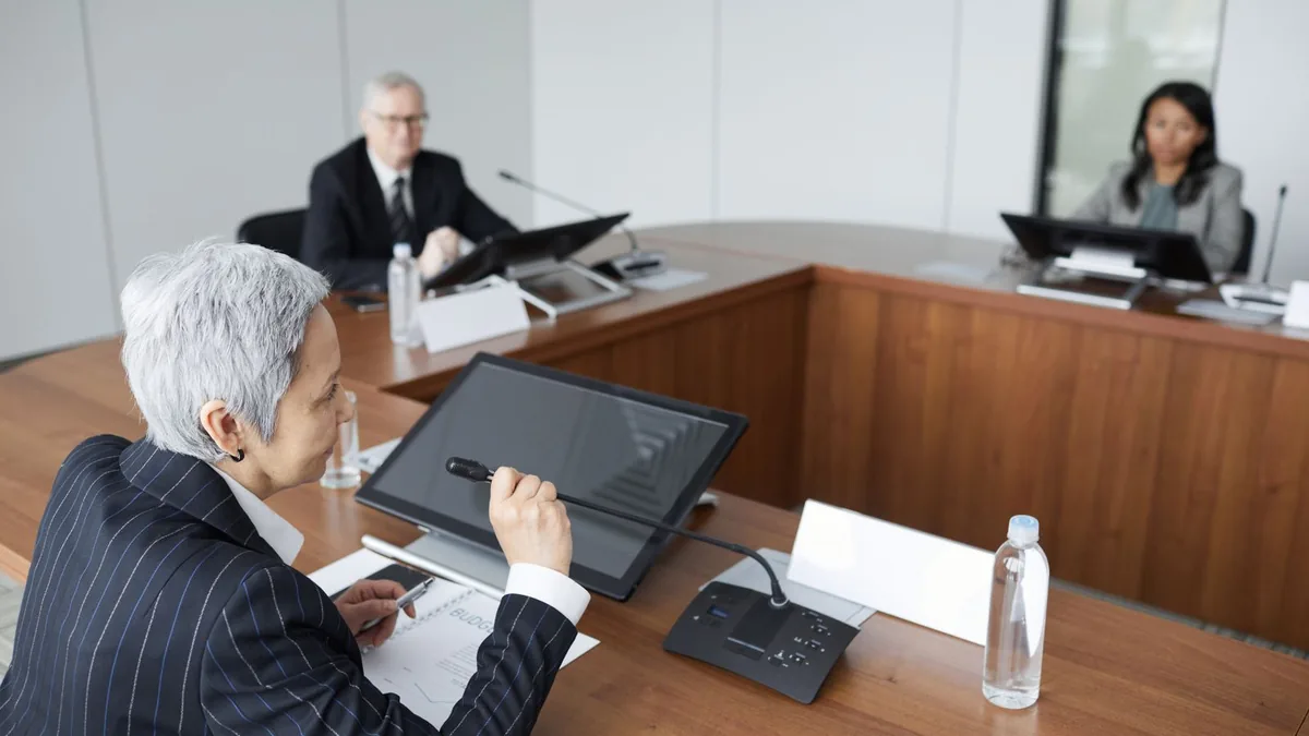 Fractional executive leading a leadership meeting at a boardroom table for an MSP