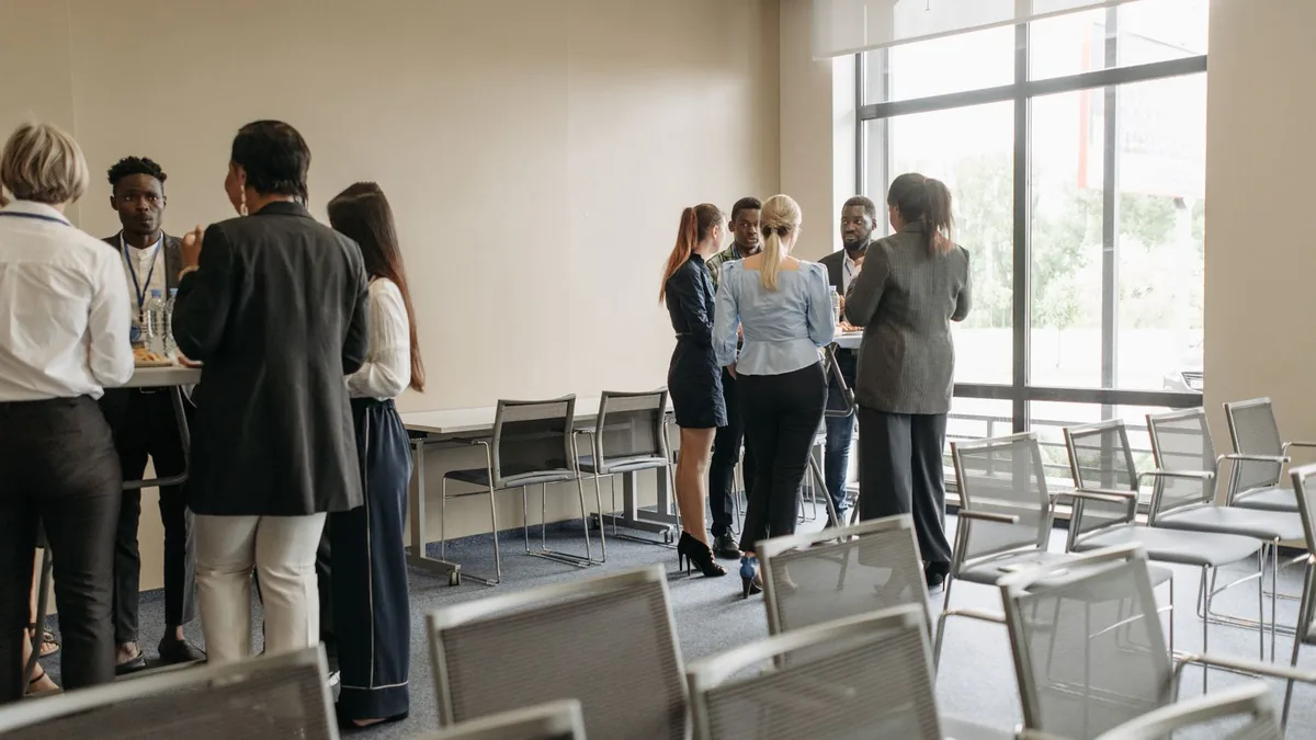 Business networking session in a conference room, mirroring LinkedIn outreach for MSPs