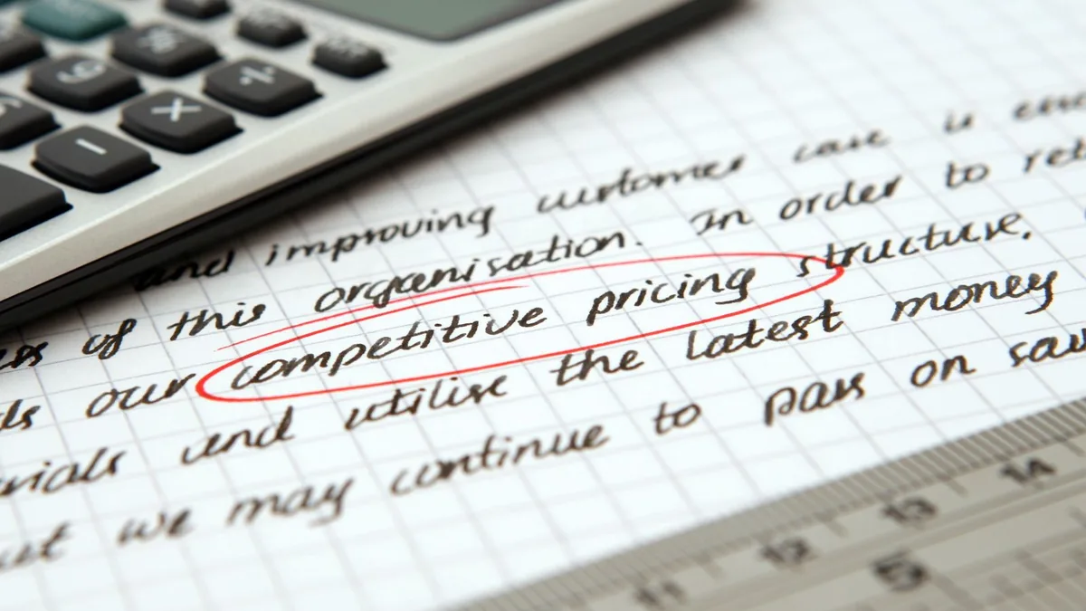 Handwritten notes with competitive pricing circled beside a calculator, for comparing C4OS pricing