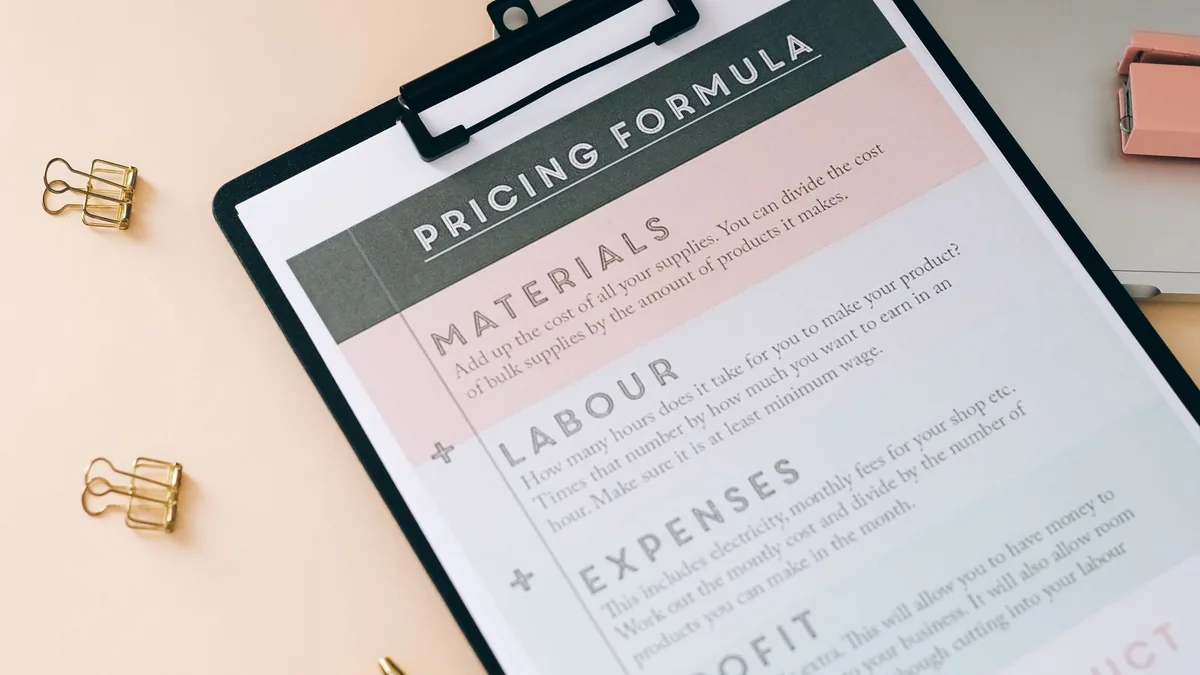 Pricing formula clipboard on a desk showing how C4OS pricing compares to building it yourself