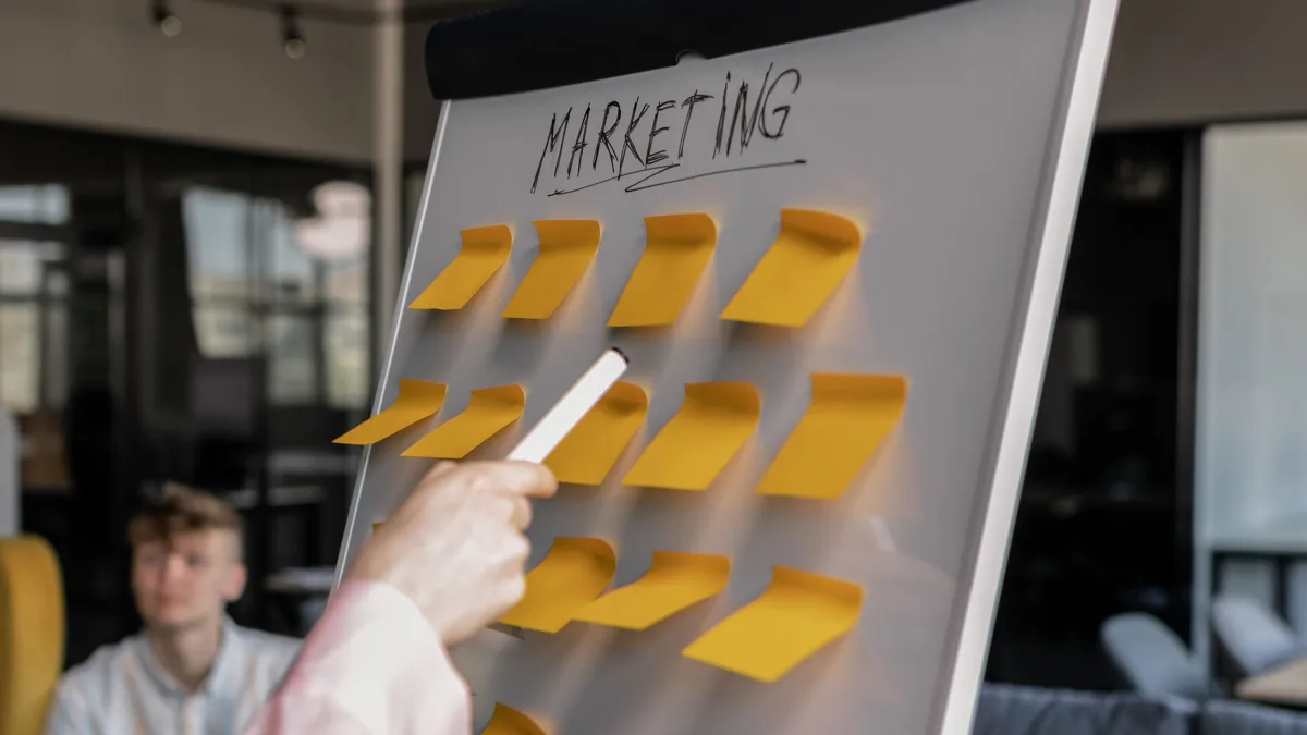 Fractional CMO cost for MSPs: marketing plan mapped on a flip chart with sticky notes