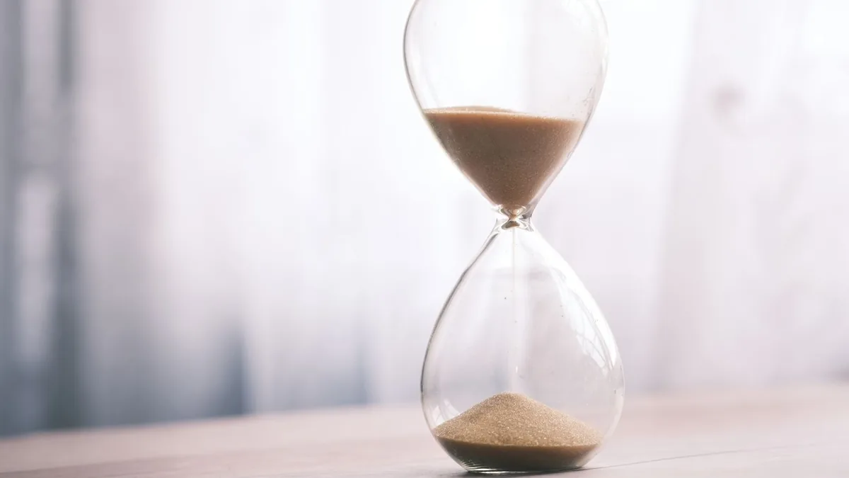 An hourglass with sand running down, a reminder that a buy-side deal pipeline takes a year or more to mature