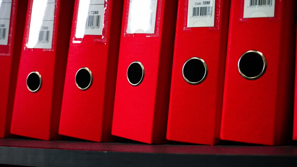 Marketing SOPs and playbooks organized and written down, like labeled binders on a shelf