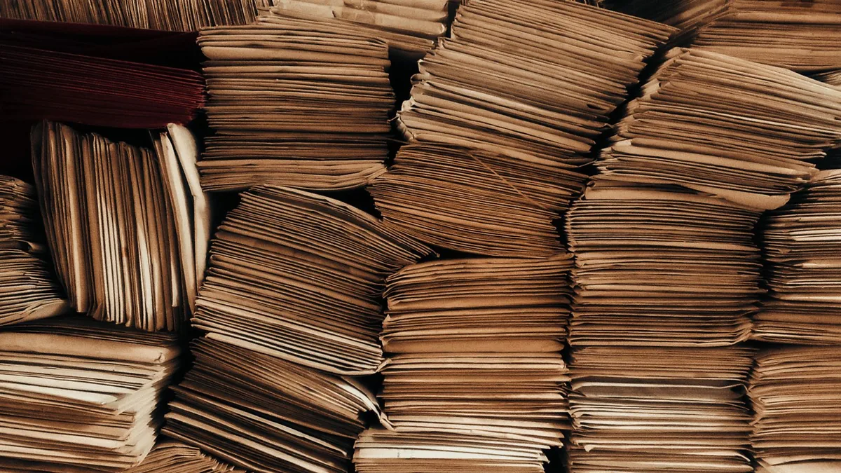 Stacks of mailed envelopes representing high-volume MSP cold outreach sent without a plan
