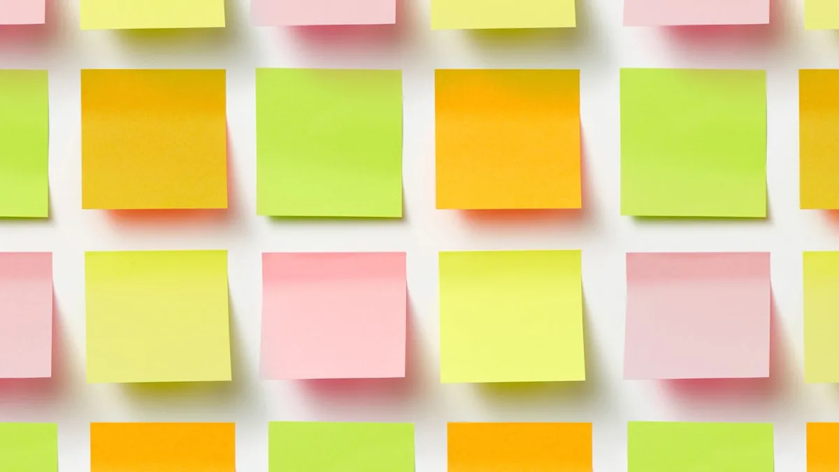 Rows of blank sticky notes laid out like the weekly scorecard of an MSP prospecting system