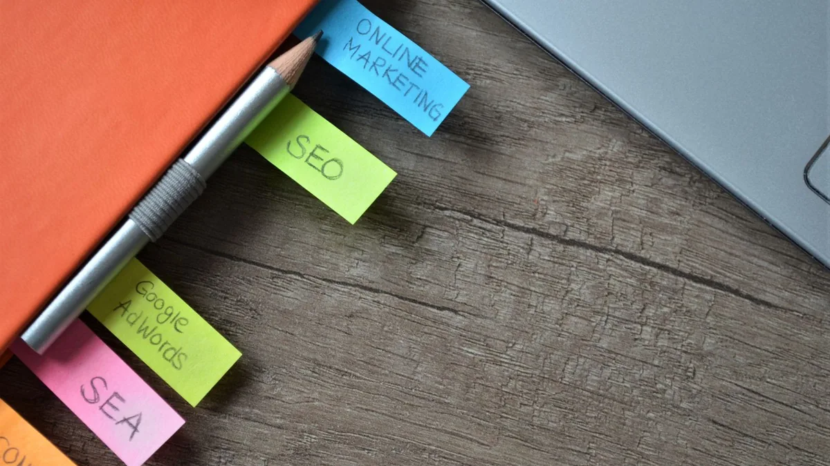 Sticky note tabs labeled SEO and online marketing on a notebook for MSP SEO services planning