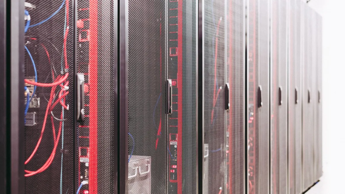 Rows of server racks with red cabling, the managed IT infrastructure behind an MSP valuation