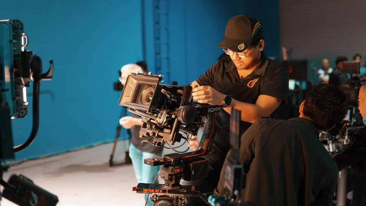 Film crew setting up cameras on a set, the crew behind MSP video production cost
