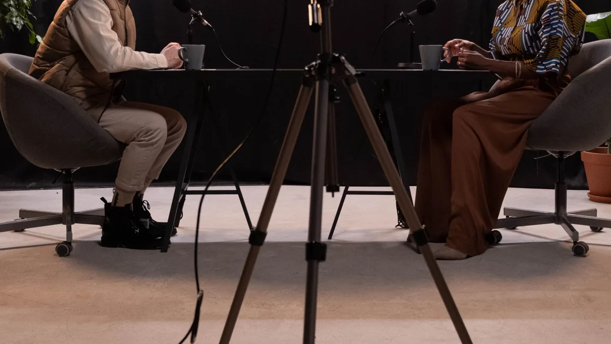 Two people recording an interview in a studio, the client conversation behind an MSP case study