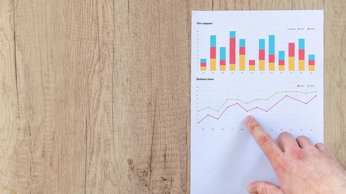 A hand pointing at a printed results chart, the measurable outcome an MSP case study leads with