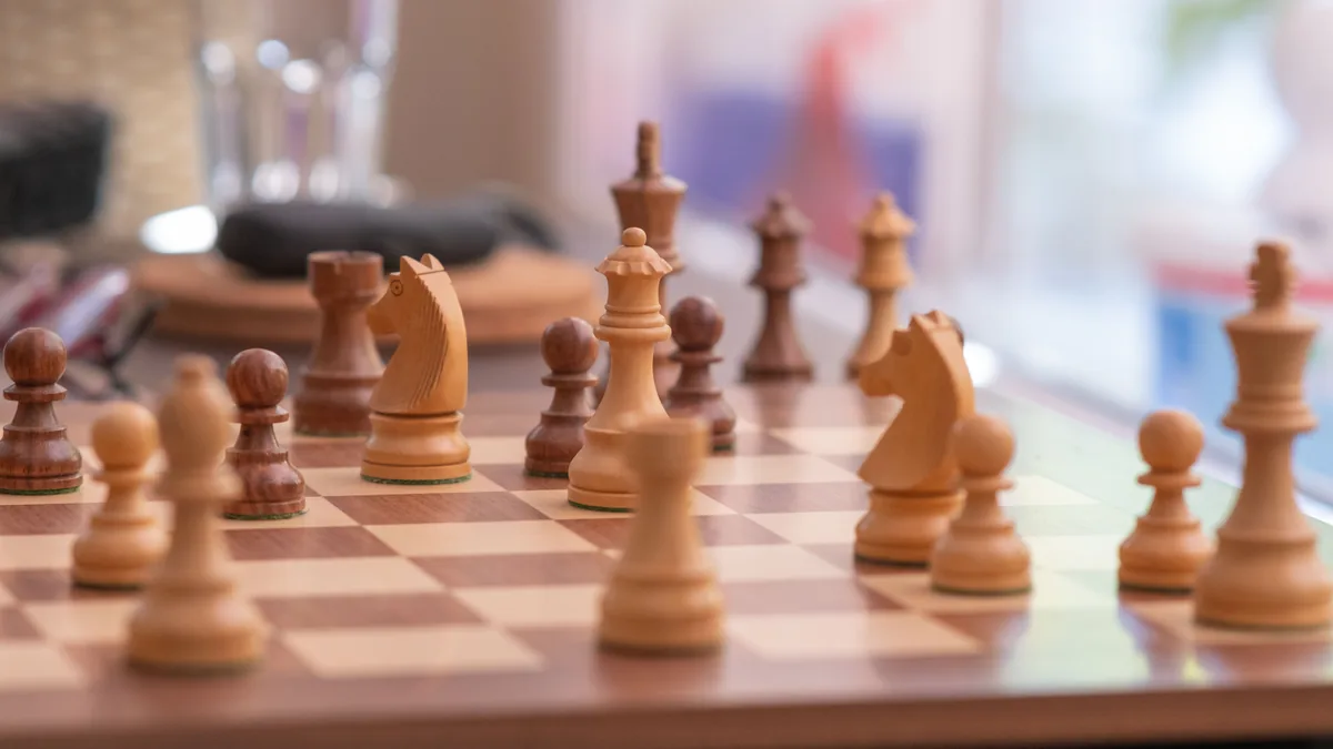 Wooden chess pieces mid-game, a picture of planning base, upside, and downside cases in an MSP forecast