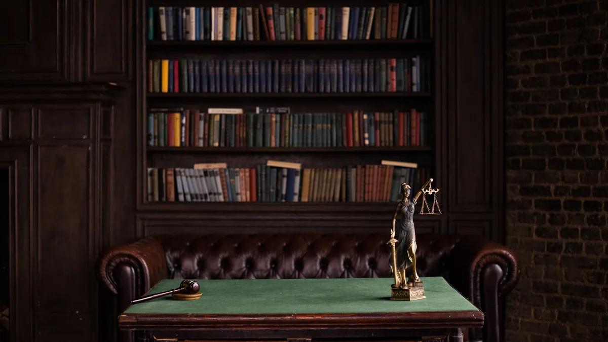 Law office library with a Lady Justice figure on the desk, the setting an MSP law firm IT page is written for