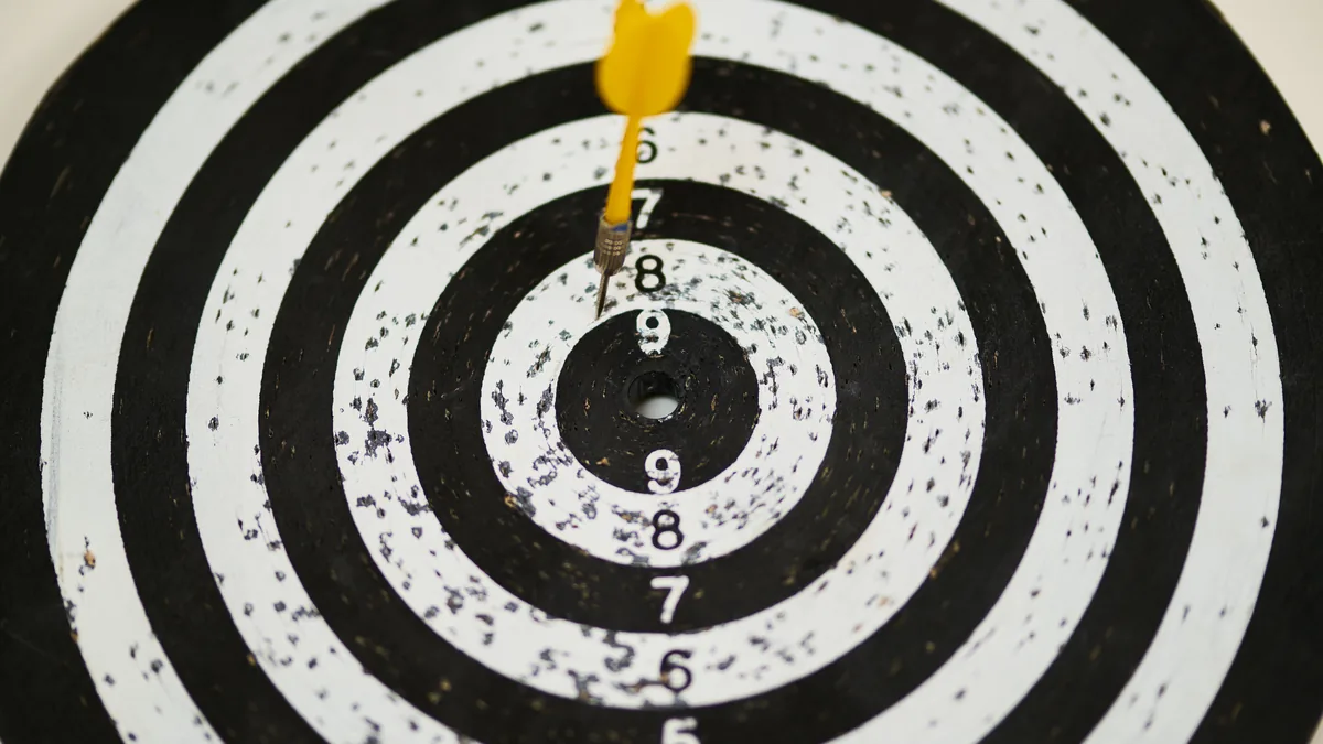 A dart in the bullseye of a black and white target, a picture of sharp MSP positioning