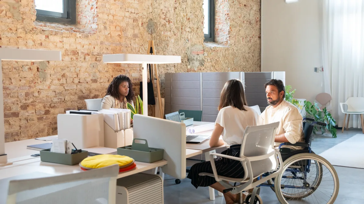 Employees at work in an office, the kind of client an MSP service page is written for